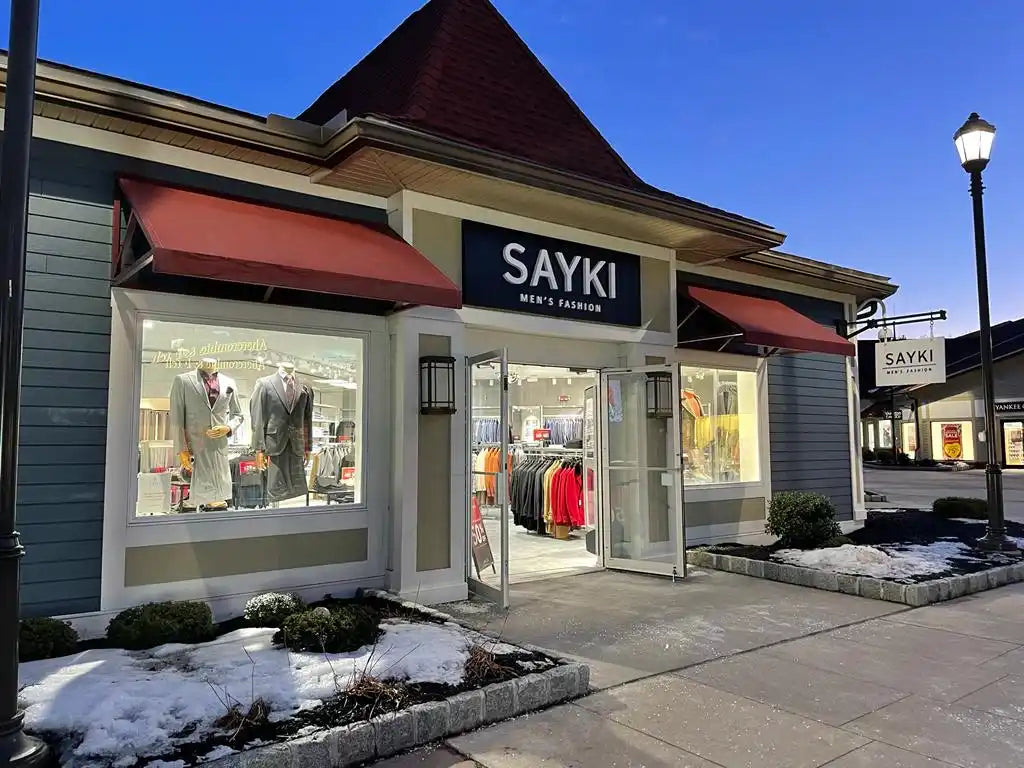 Sayki men’s clothing store with display windows and red awnings.